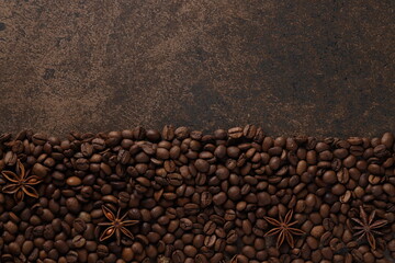 Coffee beans scattered on a textured brown background. View from above. Flat lay