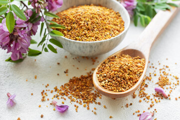 Healthy bee pollen grains.  Bee pollen on a bowl and acacia flowers.