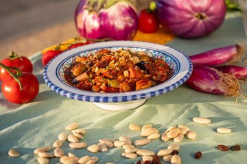caponata is a Sicilian dish consisting of chopped fried eggplant aubergine and other vegetables, seasoned with olive oil, tomato sauce