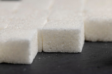 white square sugar on a black background