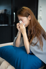 woman sitting on sofa covered with blanket freezing blowing running nose got fever caught cold...