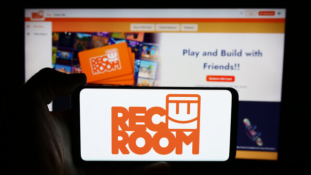 Stuttgart, Germany - 06-01-2024: Person holding cellphone with logo of US video games company Rec Room Inc. in front of business webpage. Focus on phone display.