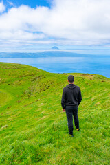 Summit at the top of the Hope Peak with man seeing the mountain on the island of Pico.São Jorge Island-Azores-Portugal.