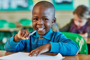 Elementary school, classroom and portrait of boy with paper for learning, knowledge and assessment....