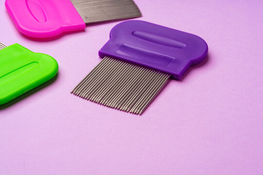Three combs for removing lice and nits on lilac background
