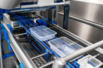Automatic food sealing machine line with empty eco-friendly plastic containers. packaging...