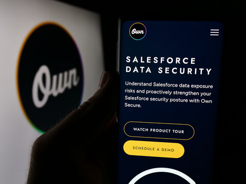 Stuttgart, Germany - 06-03-2024: Person holding smartphone with webpage of US data platform business Own Company (OwnData) in front of logo. Focus on center of phone display.