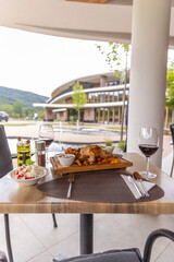 lamb chops served on a wooden board with potatoes in a restaurant