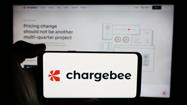 Stuttgart, Germany - 06-03-2024: Person holding cellphone with logo of US revenue growth management company Chargebee Inc. in front of business webpage. Focus on phone display.