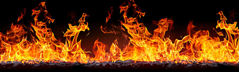 Fototapeta premium Line of intense orange flames against a black background.