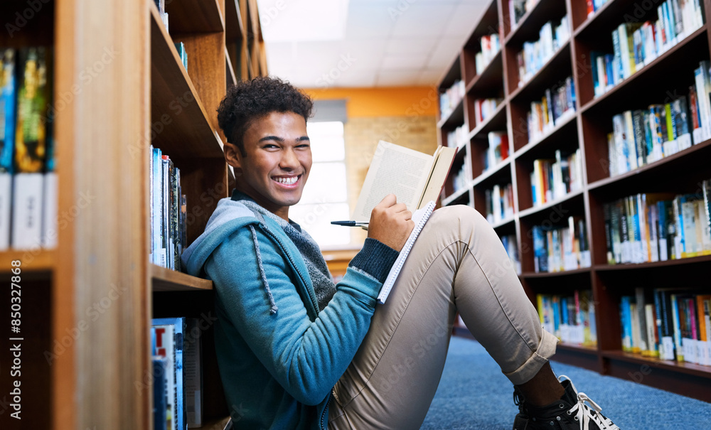 Poster Student, man and portrait with studying in library for scholarship, writing and reading a book for exam information. Education, person or happy with notebook for research notes and knowledge on floor