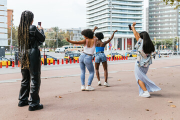 Group of female friends celebrate and have fun together in the city.