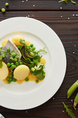 Closeup Dish With Vegetables And Fish On A White Plate. 