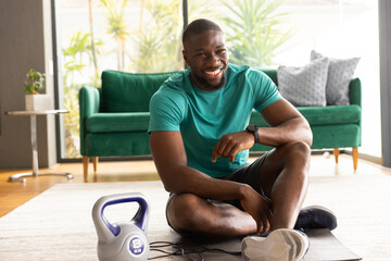 Fit African American man working out in fitness wear smiling and working out, promoting wellness