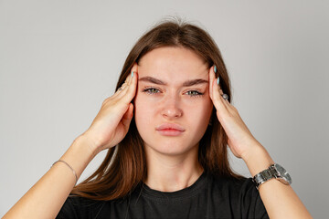 Young Woman Holding Head in Hands because of headache