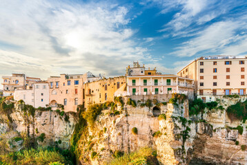 Fototapeta premium scenic travel landscape of beautiful historic town Tropea in Italy with old antique buildings, vintage houses on a high rock cliff above sea and amazing blue sky on background