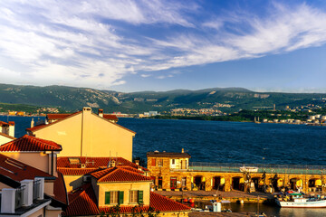 beautiful cityscape with town during sunset with blue see gulf and harbor with boats, calm water...
