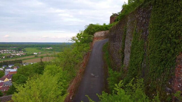 Overgrown fortifications and pathway of Gussing castle, aerial drone view
