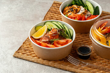 Fresh poke bowl on straw mat close up