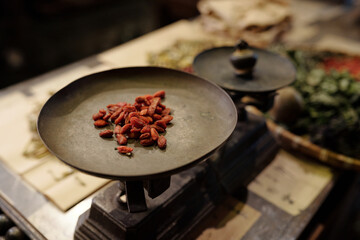 Close-up of handful of dried berries on the scales preparing for packing in drug store