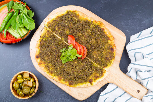 Zaater Manakeesh, arabic pizza, flat bread topped with zaatar spices, copy space. Homemade mediterranean flat bread manakish.