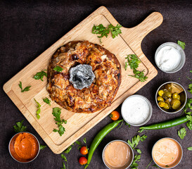 Turkish Iskender Shawarma Meat or beef or chicken with Charcoal in the center and sauces around. Cook fries grilled meat shawarma. Hot fresh delicious kebabs - a fine selection of street food.