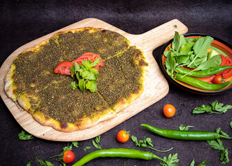 Zaater Manakeesh, arabic pizza, flat bread topped with zaatar spices, copy space. Homemade...