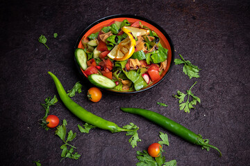 Arabic or Turkish Rocca Fresh Salad. Fresh green leaves, lettuce, arugula, rocket salad with mozzarella, pomegranate seeds, avocado, onions and coriander leaves.
