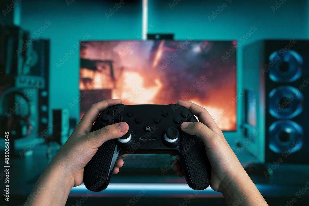 Poster dynamic image of hands holding a gamepad in front of a modern gaming computer, with vibrant led ligh