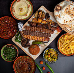 Arabic grilled arabic food dishes kebab, dolma, mansaf, shawarma Turkish and Arabic Traditional Ramadan Mix Vali Kebab Plate inside Adana, Urfa, Chicken, Lamb, Liver and Beef on bread on table