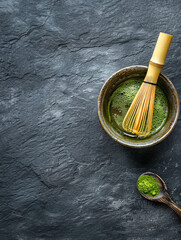 Process of cooking Matcha green tea in a bowl with bamboo stirrer on empty stone dark background with space for text or inscriptions, top view
