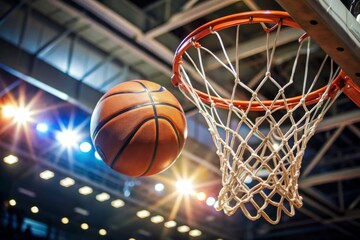 Basketball scoring a basket as it goes through the hoop and making a swish in the net