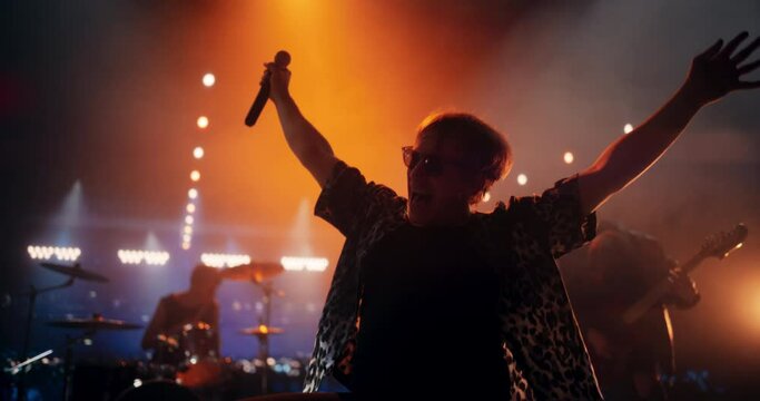 Energetic Rock Band Performing on a Nightclub Stage with Dynamic Lights and Special Effects. Portrait of an Artist Creating a Unique Show Experience With Powerful Alternative Songs