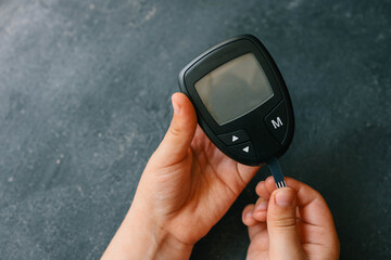 Close-up Of Woman Hands Testing High Blood Sugar With Glucometer