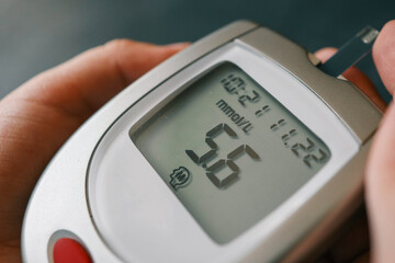 Close-up Of Woman Hands Testing High Blood Sugar With Glucometer
