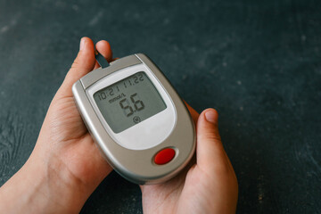 Close-up Of Woman Hands Testing High Blood Sugar With Glucometer