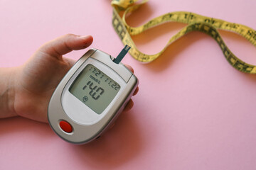 Sugar level measuring tool and measuring tape on table, weight loss concept