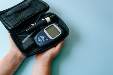 Glucometer top view on blue background