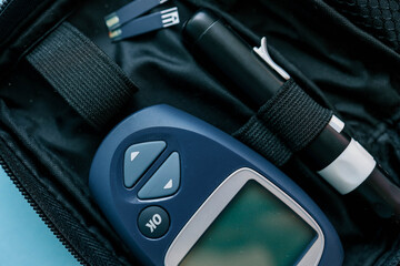Glucometer top view on blue background