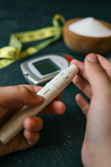 Man measuring blood sugar, close-up
