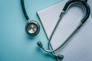 Stethoscope on light blue background, closeup. Space for text