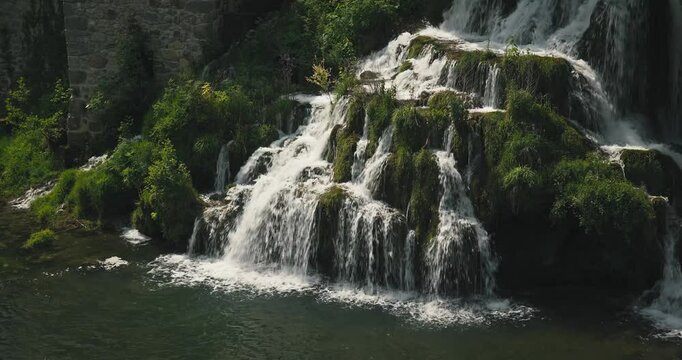 Scenic waterfall cascading over moss-covered rocks in Rastoke, Croatia