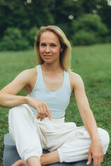 young woman athlete in sportswear practices yoga, enjoys training