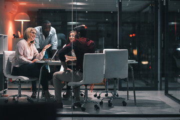 Business meeting, laptop and support for design at night in office, creative agency and overtime...