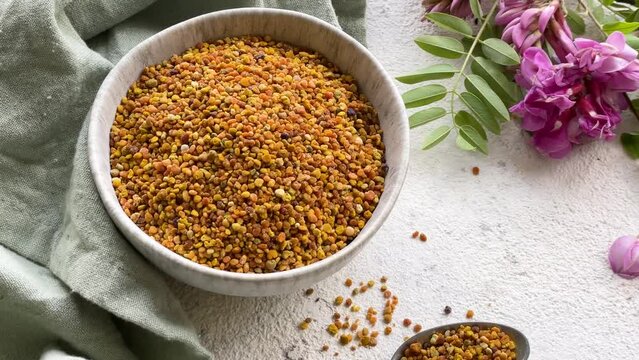 Healthy bee pollen grains.  Bee pollen on a bowl and acacia flowers