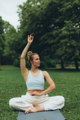 young woman athlete in sportswear practices yoga, enjoys training