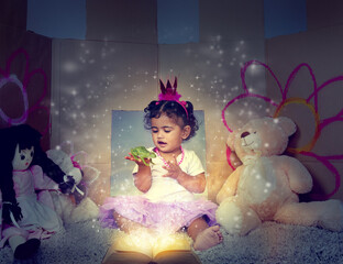 Little girl, book and reading with fairy tale for princess and frog in make belief, dream or imagination at home. Happy child, toddler or baby with story or pixie dust for fantasy or cosplay at house
