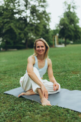 young woman athlete in sportswear practices yoga, enjoys training