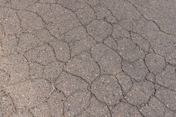 a part of a highway covered with cracked asphalt