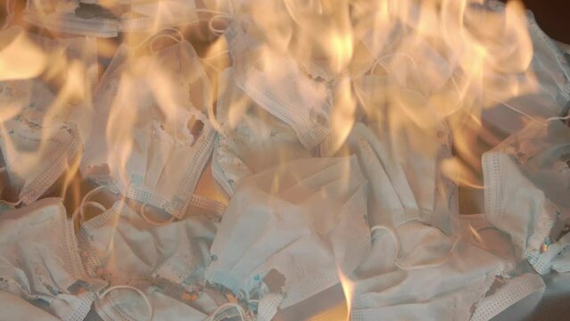 Disposable Masks Burning. A lot of masks on fire. Is this the end onf the pandemic